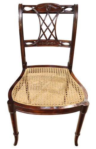 An Edwardian dark mahogany side chair featuring a woven cane seat, pierced lattice splat, and turned front legs. View V