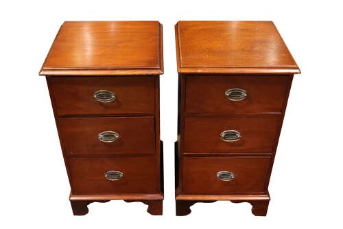 A pair of Victorian mahogany bedside chests featuring three drawers each, brass oval handles, and shaped bracket feet. View III