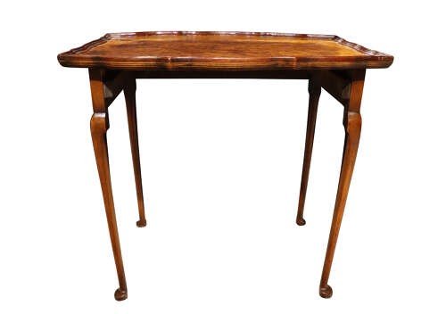 A set of three nested 1920s burr walnut side tables featuring shaped piecrust tops and slender cabriole legs. View V