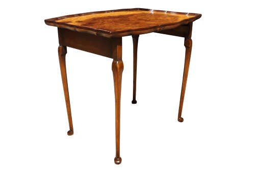 A set of three nested 1920s burr walnut side tables featuring shaped piecrust tops and slender cabriole legs. View VI