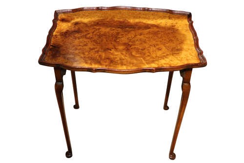 A set of three nested 1920s burr walnut side tables featuring shaped piecrust tops and slender cabriole legs. View VII