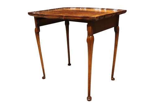 A set of three nested 1920s burr walnut side tables featuring shaped piecrust tops and slender cabriole legs. View VIII