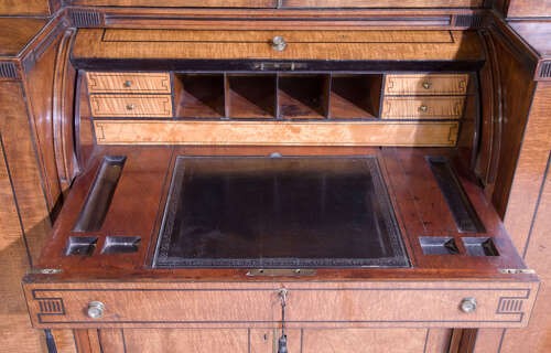 A Regency mahogany breakfront secretaire bookcase with glazed doors, satinwood veneers, and ebony inlay detail. View VII