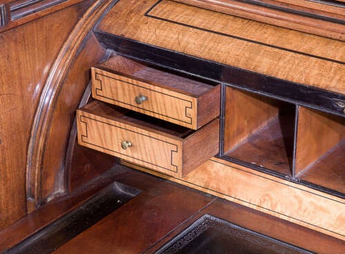 A Regency mahogany breakfront secretaire bookcase with glazed doors, satinwood veneers, and ebony inlay detail. View IX