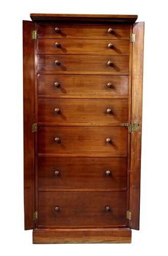 A tall mid-19th century mahogany Wellington chest featuring eight graduated drawers with turned wooden knobs and a side-locking hinged pilaster. View III