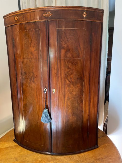 Mahogany Bow Front Corner Cupboard .