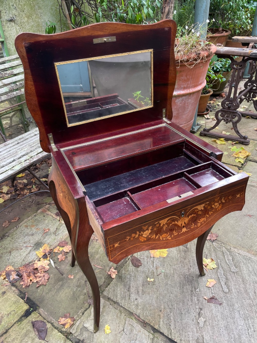 A late 19th-century French marquetry sewing table featuring floral wood inlay on a serpentine top, brass edging, and slender cabriole legs. View III