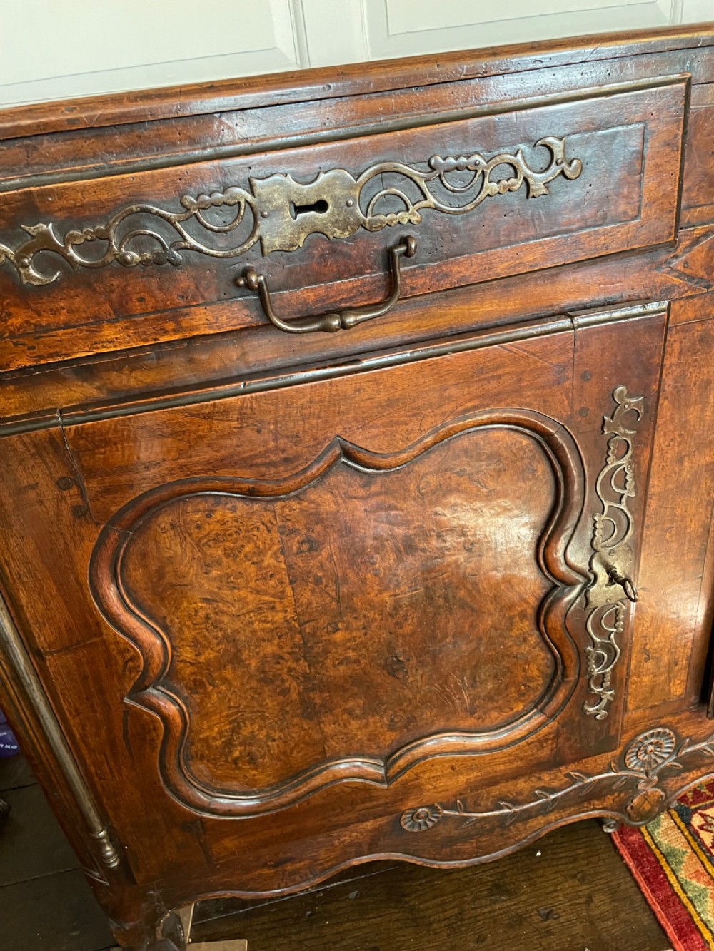 An 18th-century French walnut buffet featuring two upper drawers above two moulded panel doors with brass escutcheons and a carved apron. View II