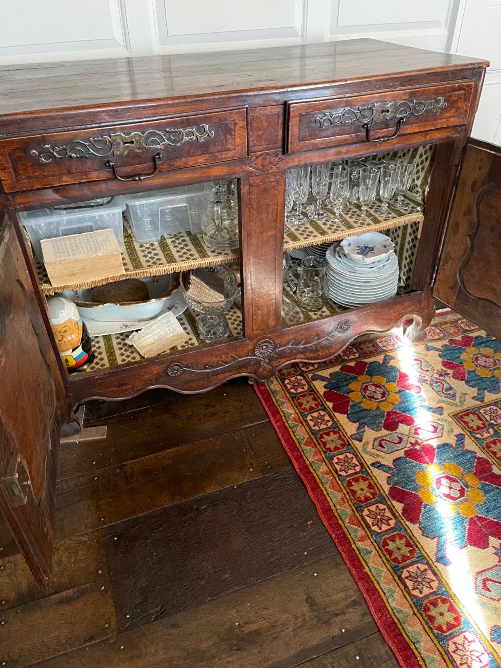 An 18th-century French walnut buffet featuring two upper drawers above two moulded panel doors with brass escutcheons and a carved apron. View V