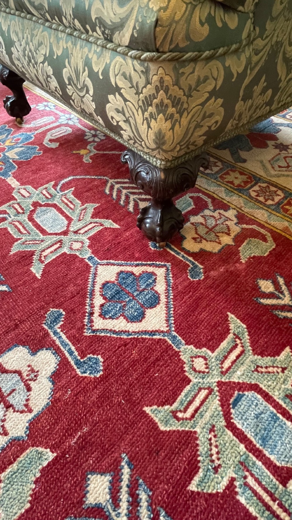 A matching pair of fully upholstered armchairs covered in pale blue and cream floral damask fabric with dark turned wooden legs. View III