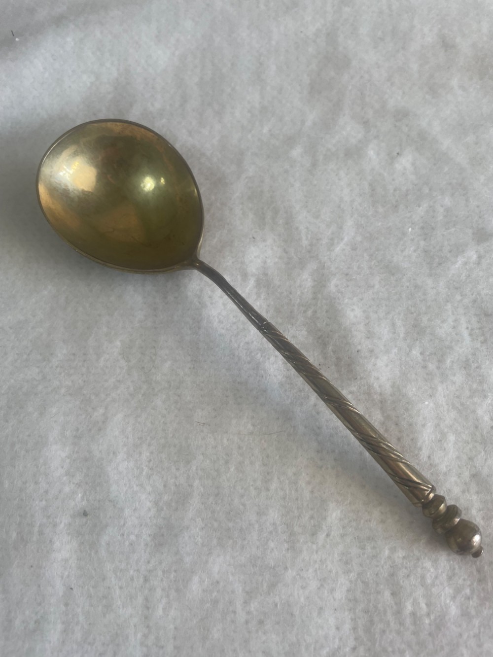 An antique Russian silver spoon featuring a twisted stem, a knopped finial, and an oval bowl decorated with black niello foliate scrollwork on the reverse. View II