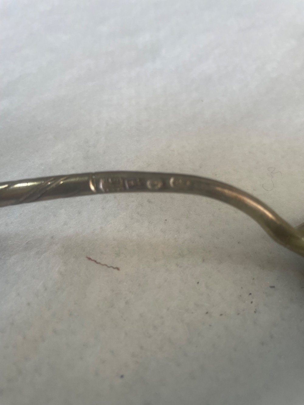 An antique Russian silver spoon featuring a twisted stem, a knopped finial, and an oval bowl decorated with black niello foliate scrollwork on the reverse. View III