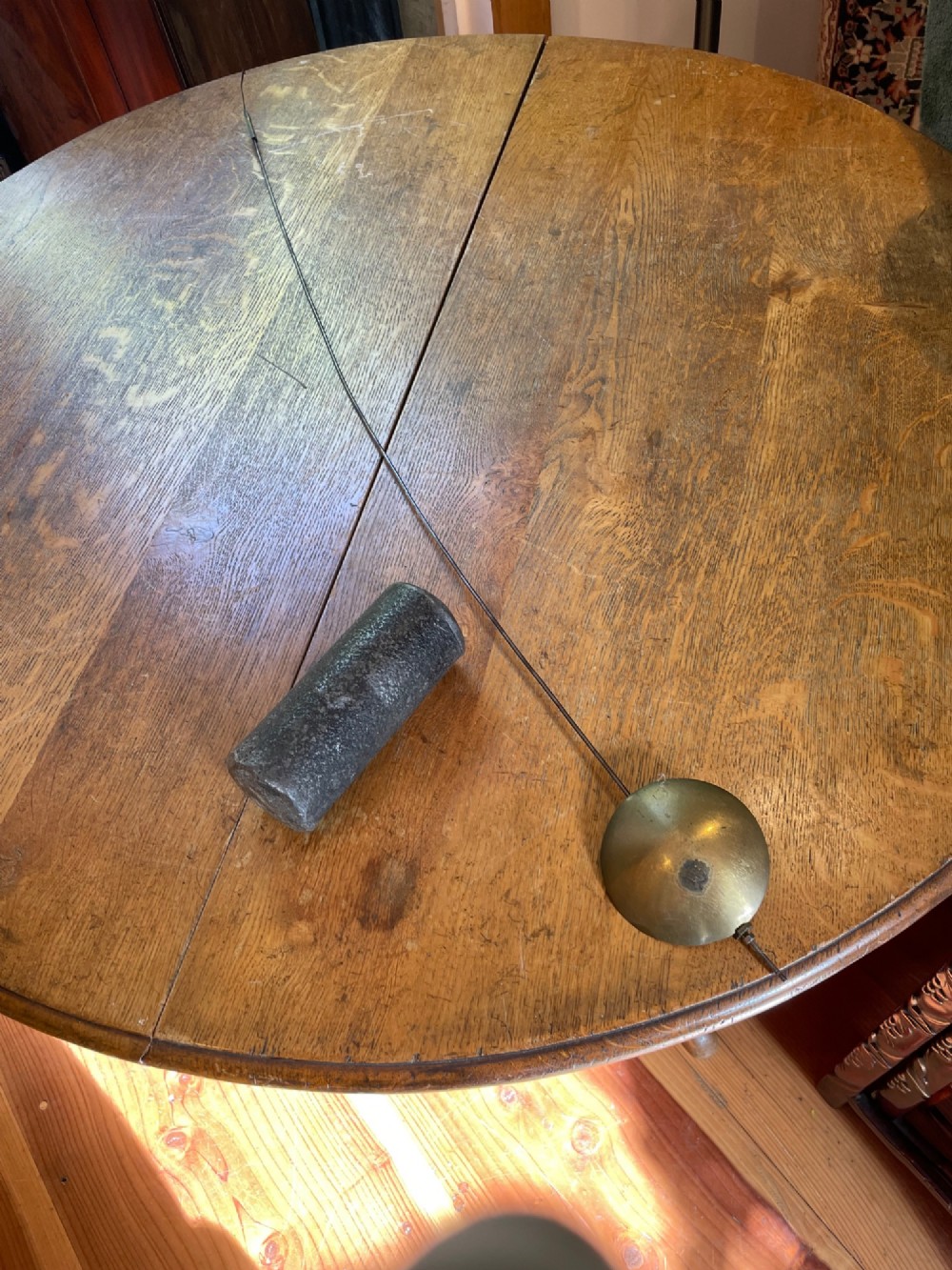 An antique Georgian oak longcase clock featuring a square glass hood door, a brass dial with Roman numerals, and a slim trunk with a hinged door. View II