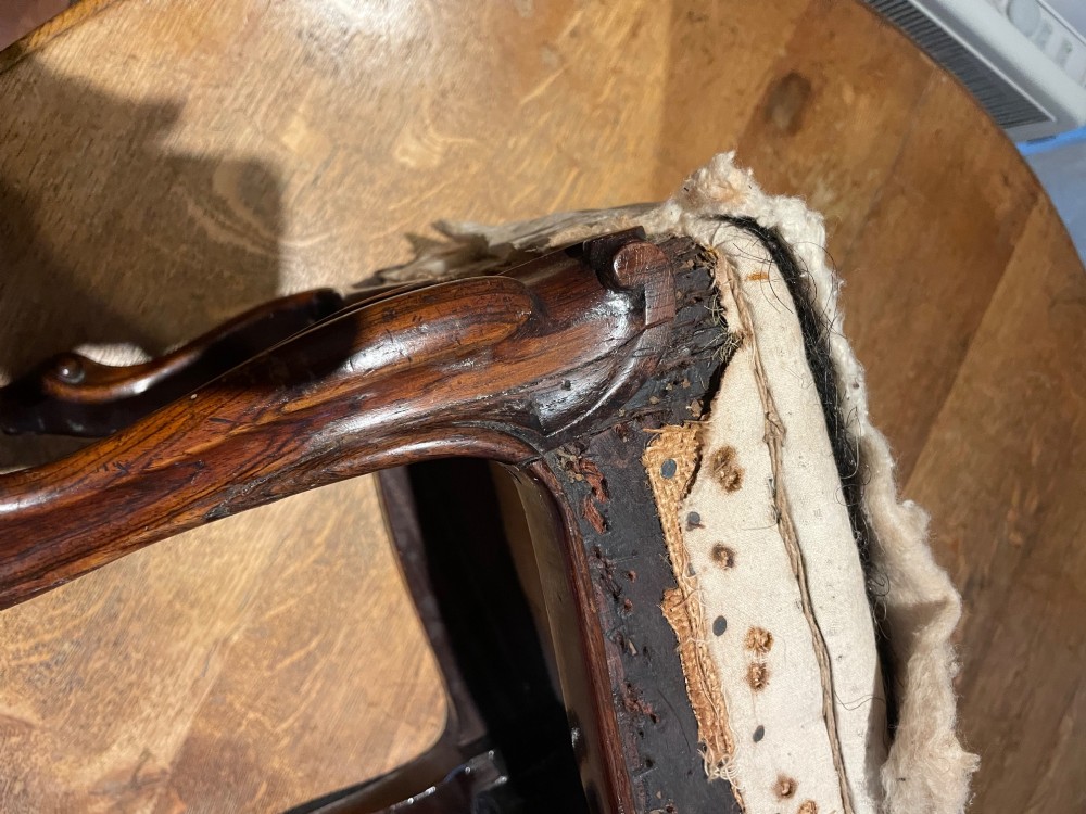 A pair of antique rosewood footstools featuring carved cabriole legs and calico-wrapped padded tops. View III