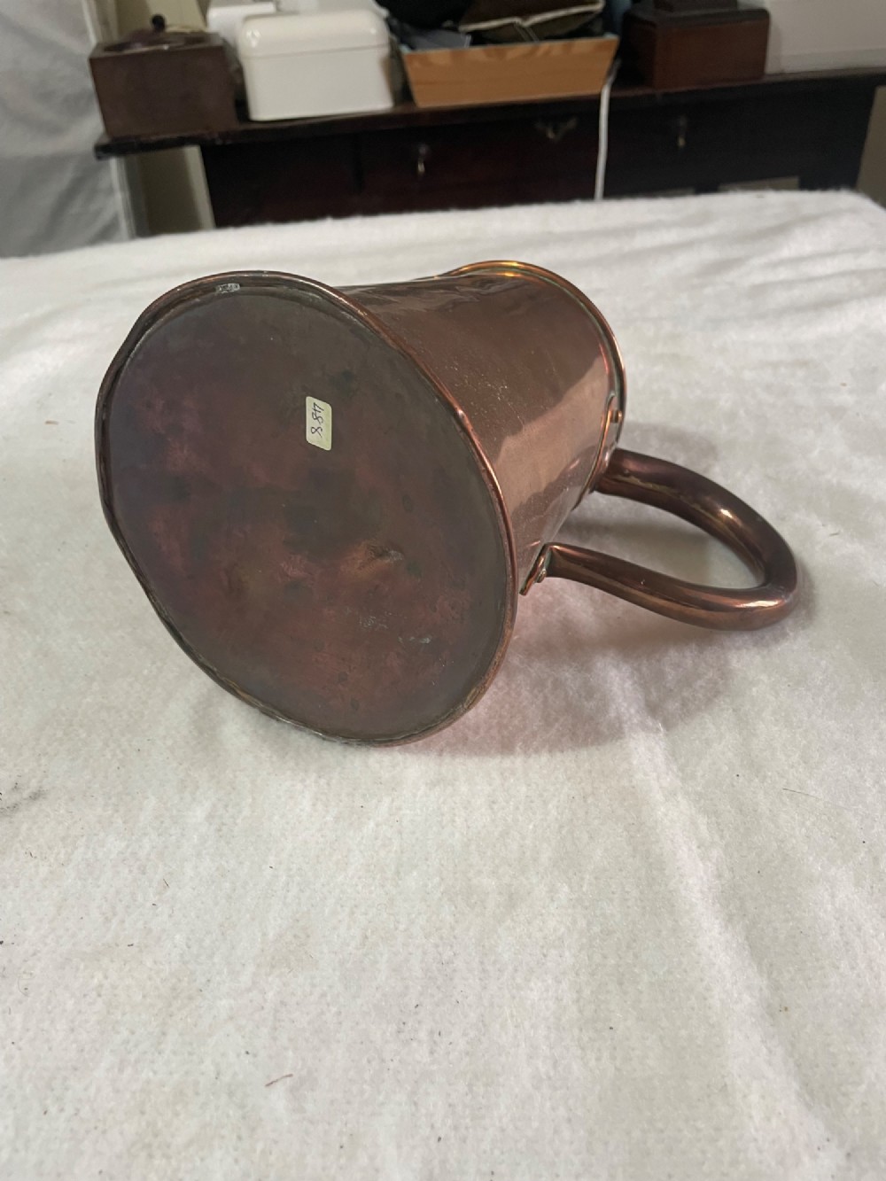 A Victorian copper jug featuring a tapered cylindrical body, a distinct pouring spout, and a thick riveted loop handle. View III