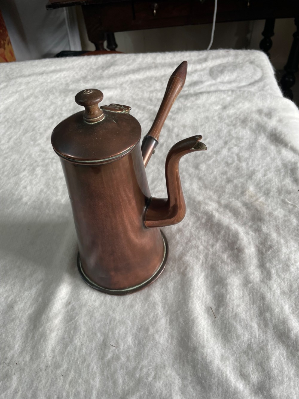 An antique tapered copper chocolate pot featuring a side-mounted turned wooden handle, a curved spout, and visible dovetail joinery. View II