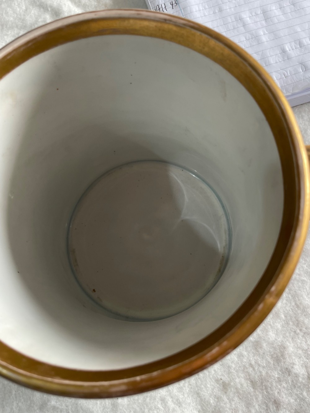 A cobalt blue porcelain two-handled loving cup featuring a hand-painted floral bouquet within a gilded ornate frame. View IV