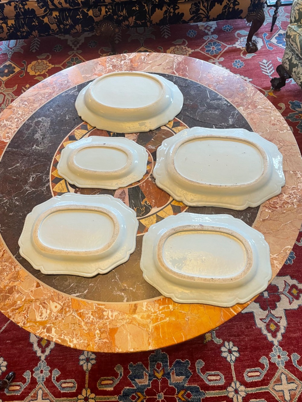 A set of five antique blue and white Chinese export porcelain oval platters with scalloped rims, featuring hand-painted landscape scenes. View II