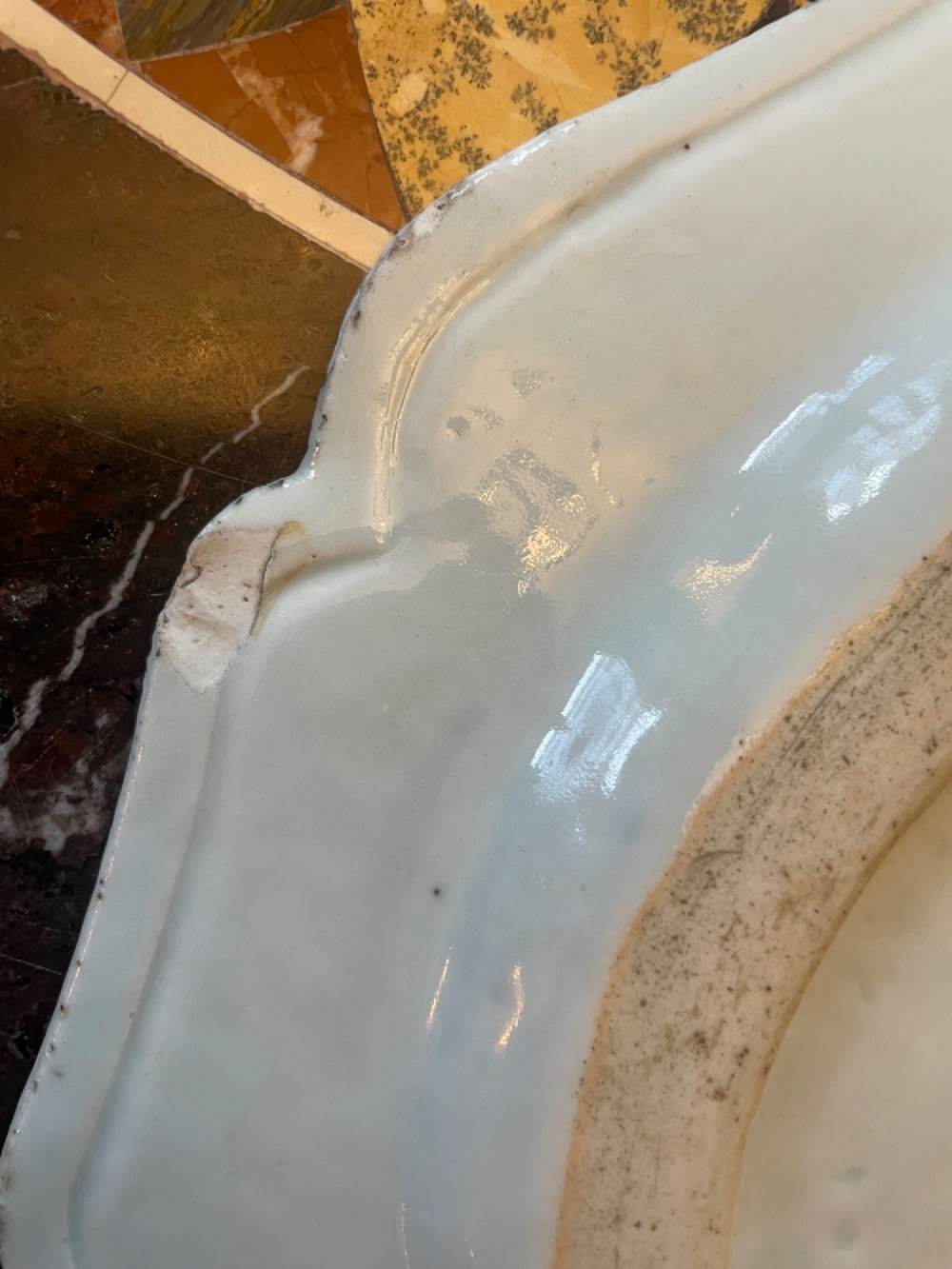 A set of five antique blue and white Chinese export porcelain oval platters with scalloped rims, featuring hand-painted landscape scenes. View III