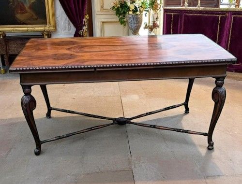 A BURR WALNUT EXTENDING DINING CENTRE TABLE