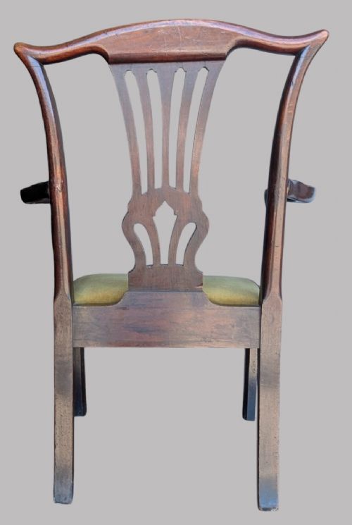 A Georgian mahogany elbow chair featuring a carved pierced back splat, curved arms, and an olive green fabric seat cushion on square legs. View IV