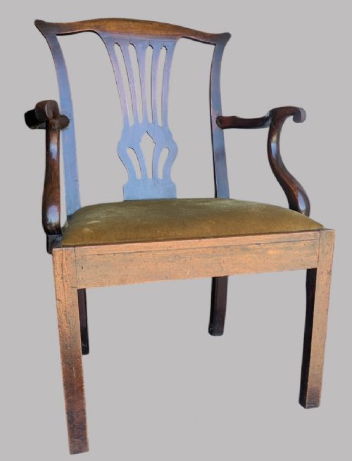 A Georgian mahogany elbow chair featuring a carved pierced back splat, curved arms, and an olive green fabric seat cushion on square legs. View VII