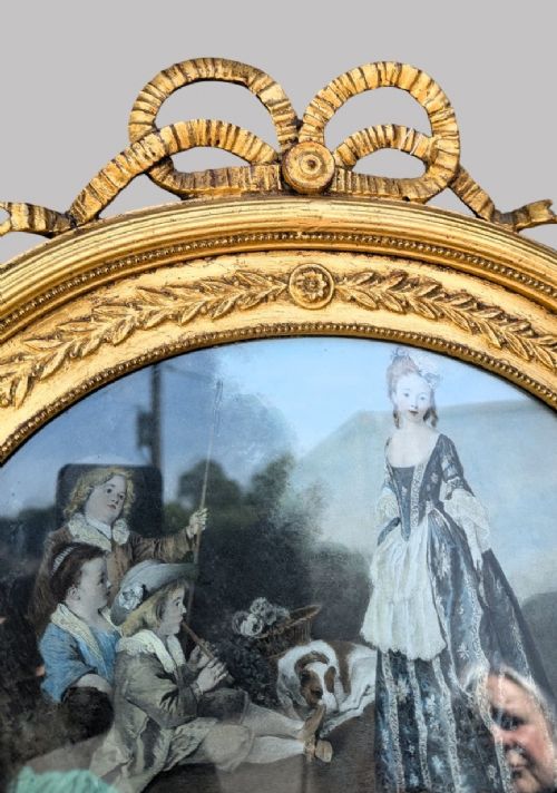 An arched giltwood pier mirror featuring a ribbon bow crest and an upper oval painted scene framed by laurel wreaths above a glass plate. View VI