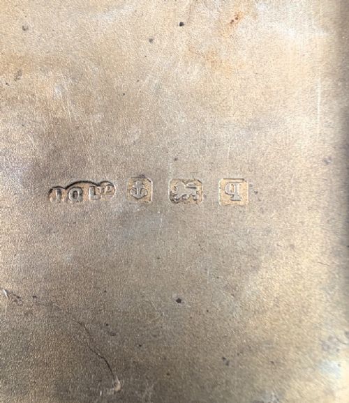 An open antique sterling silver cigarette case featuring hand-engraved foliate scrollwork and a blank shield cartouche on the outer cover. View III