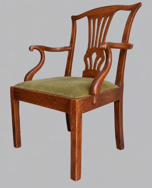 fig 1. A Georgian Chippendale style mahogany elbow chair with a pierced splat back, shaped arms, and a green velvet seat.