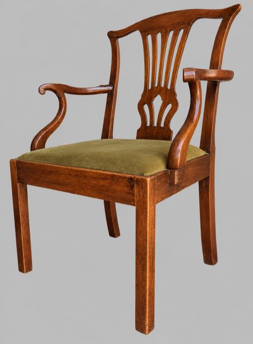 fig 2. A Georgian Chippendale style mahogany elbow chair with a pierced splat back, shaped arms, and a green velvet seat.