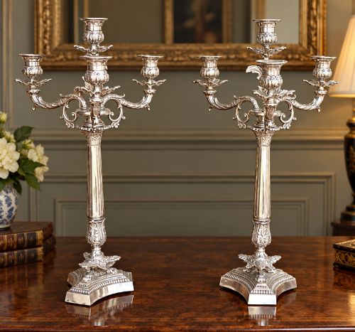 fig 2. A pair of Victorian silver-plated four-branch candelabras featuring ornate acanthus leaf motifs, fluted columns, and decorative bases.