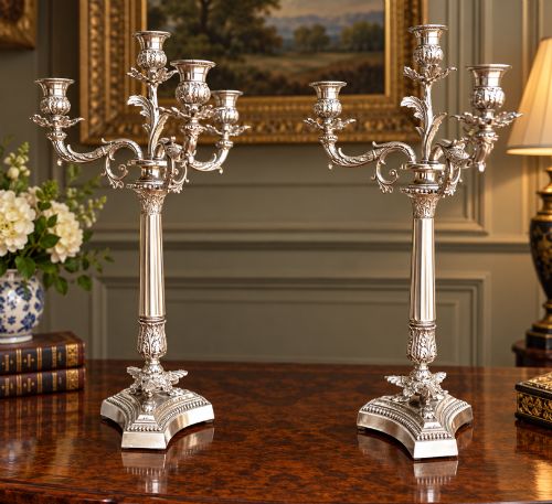 fig 1. A pair of Victorian silver-plated four-branch candelabras featuring ornate acanthus leaf motifs, fluted columns, and decorative bases.