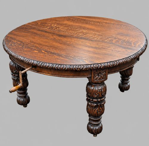 fig 3. A late 19th-century oak extending dining table featuring a quarter-sawn wood top, carved apron moulding, and turned legs.