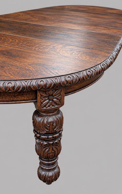 A late 19th-century oak extending dining table featuring a quarter-sawn wood top, carved apron moulding, and turned legs. View VII