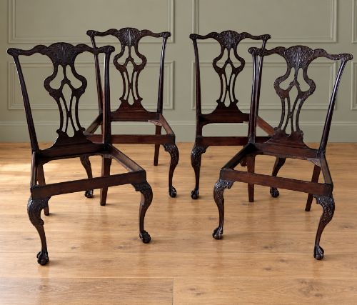 fig 1. A set of four mahogany Chippendale style dining chairs featuring carved pierced splats, gold-coloured velvet seats, and cabriole front legs with ball-and-claw feet.