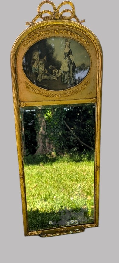 An arched giltwood pier mirror featuring a ribbon bow crest and an upper oval painted scene framed by laurel wreaths above a glass plate. View IX