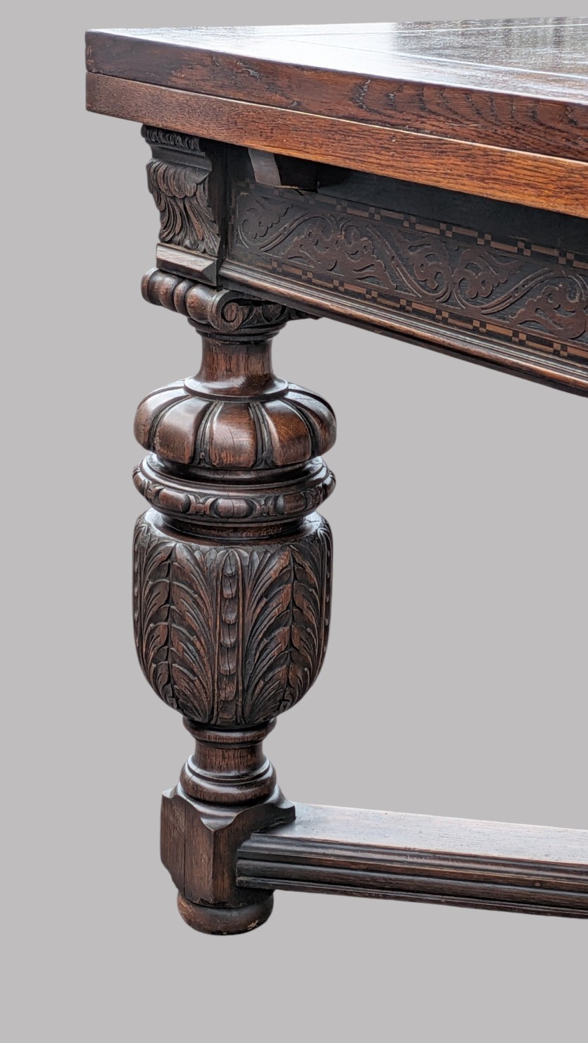 A rectangular extending oak dining table showing a quarter-sawn timber surface and carved bulbous legs underneath. View V