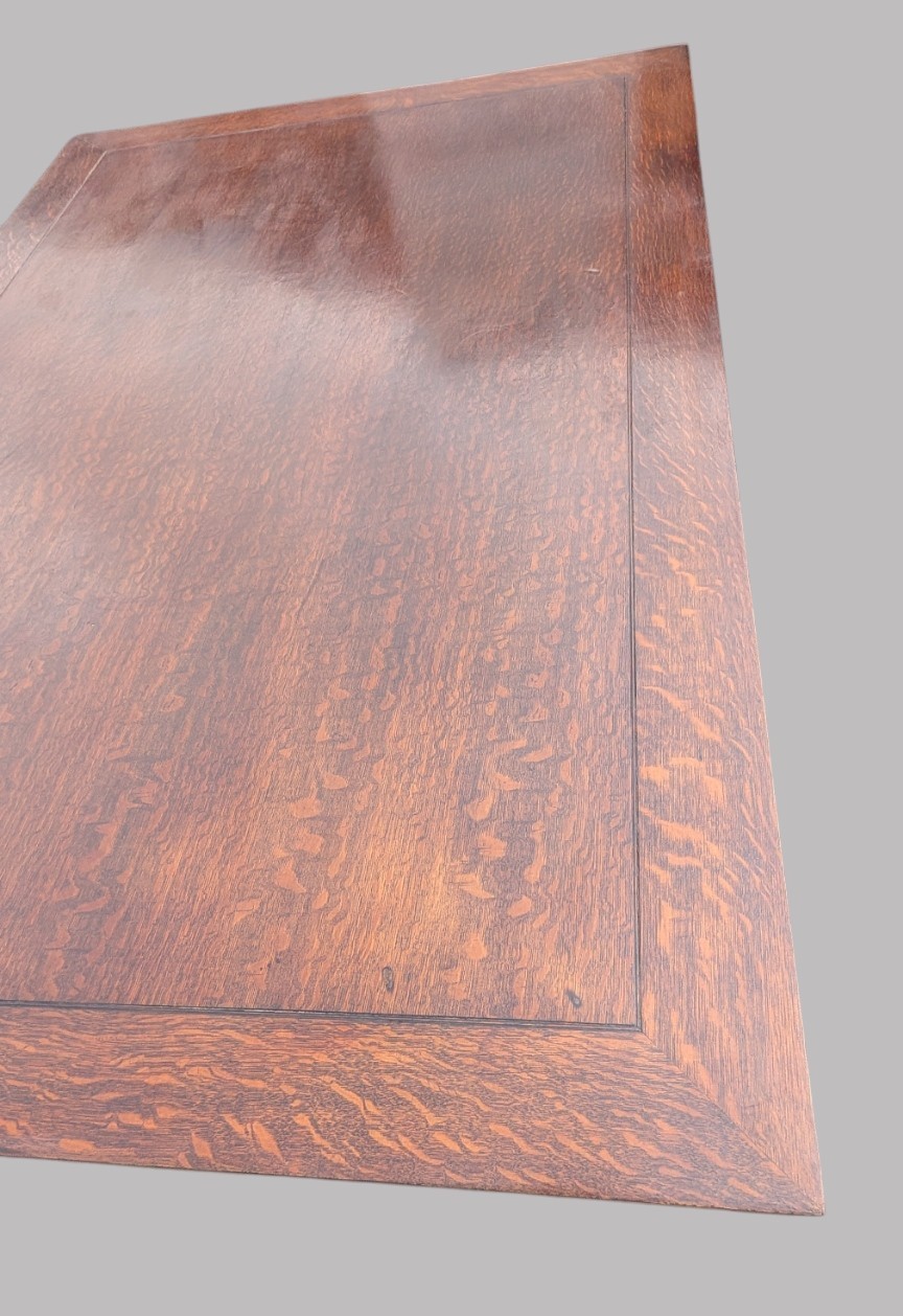 A rectangular extending oak dining table showing a quarter-sawn timber surface and carved bulbous legs underneath. View X