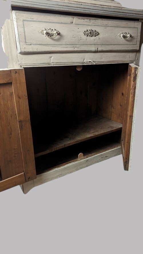 A two-tier 19th-century French painted cupboard featuring upper glazed doors with a carved pediment and lower panelled cabinet doors. View V