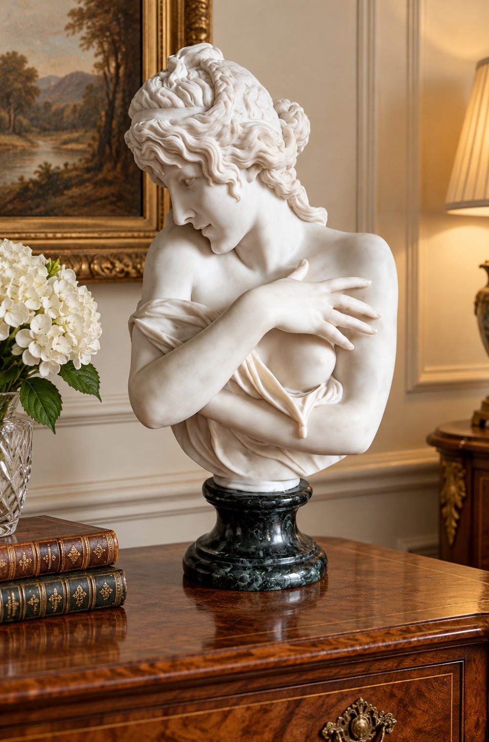 A carved white marble bust of a young woman with coiled hair and draped classical attire, mounted on a dark green marble circular plinth. View X