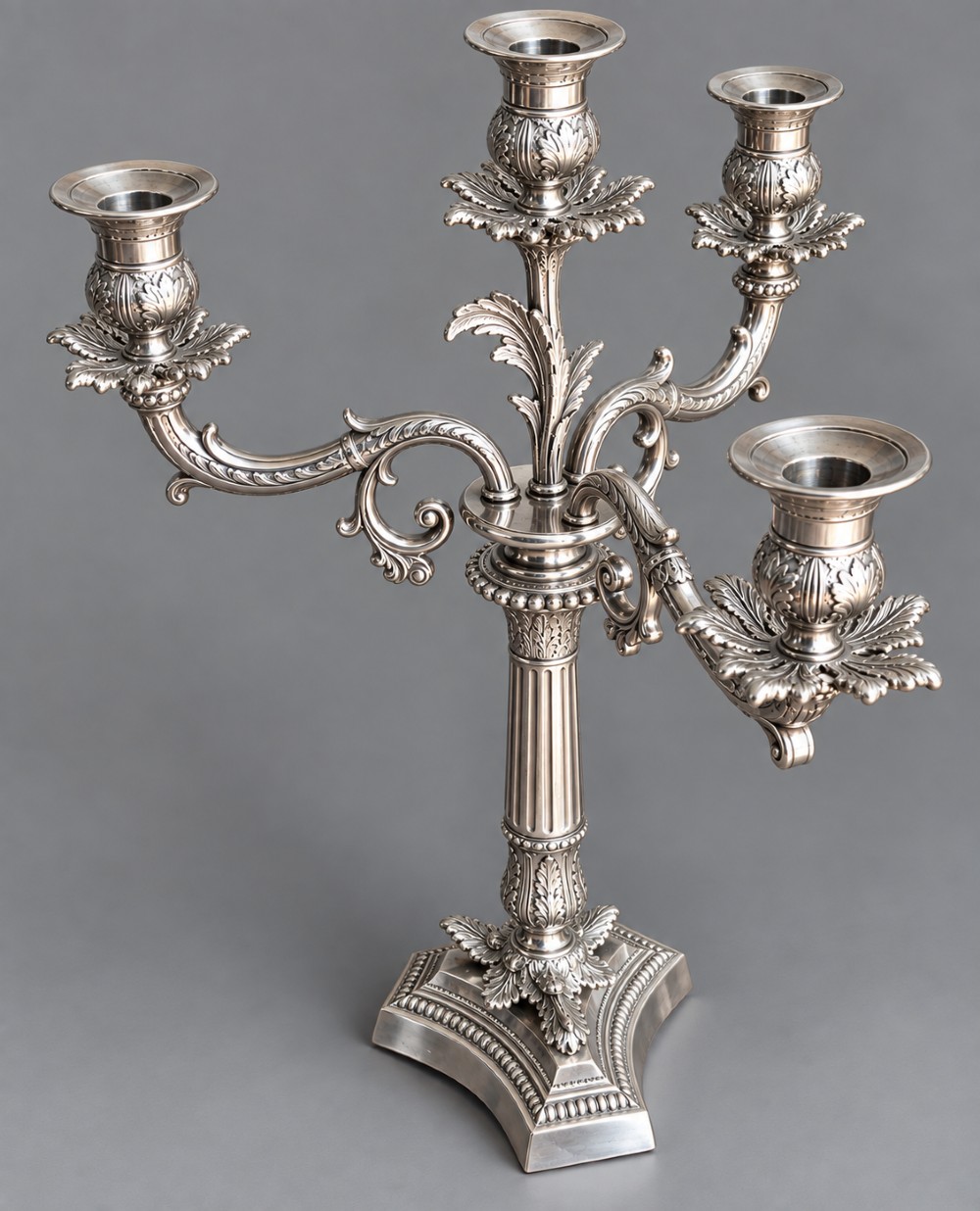 A pair of Victorian silver-plated four-branch candelabras featuring ornate acanthus leaf motifs, fluted columns, and decorative bases. View V