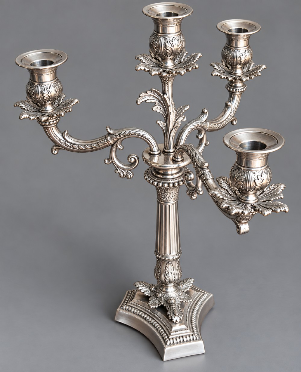 A pair of Victorian silver-plated four-branch candelabras featuring ornate acanthus leaf motifs, fluted columns, and decorative bases. View VI
