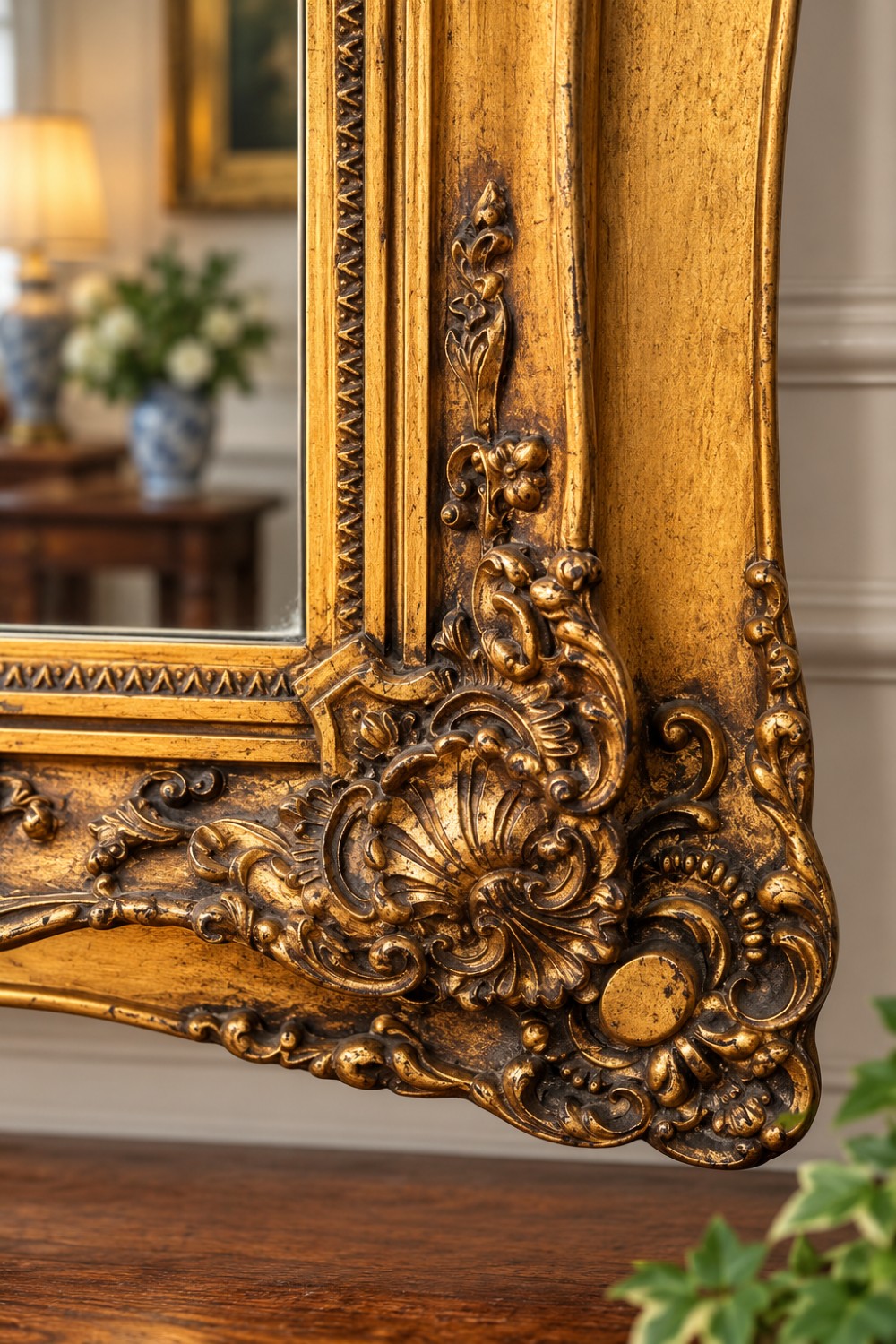 A rectangular giltwood wall mirror featuring an undulating carved frame, a painted landscape scene in the upper panel, and a mirror pane below. View II