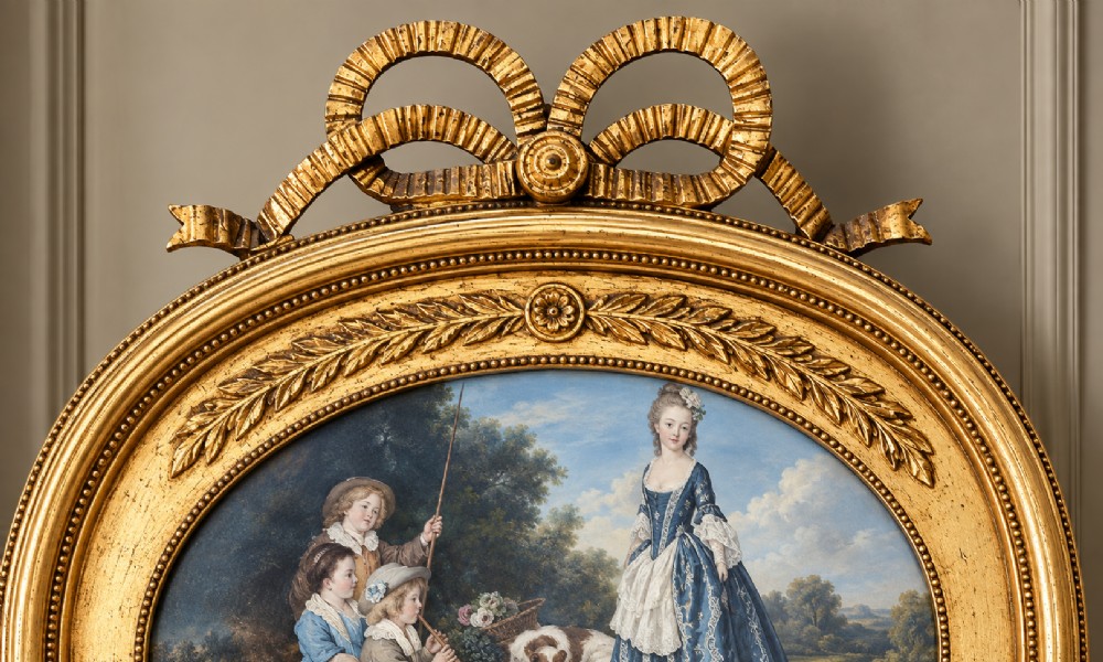 A tall Victorian giltwood pier mirror featuring a carved ribbon bow crest, an oval inset decorative panel at the top, and a rectangular glass mirror plate. View III