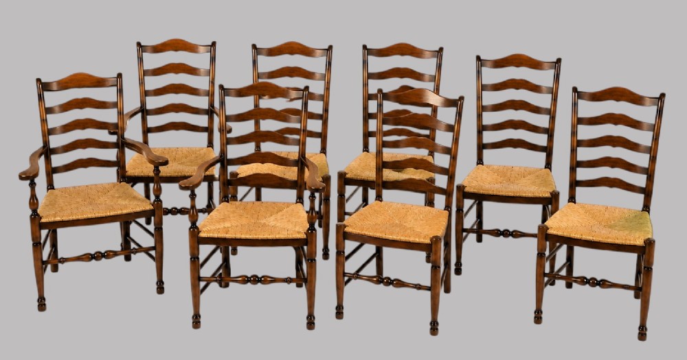 A set of eight dark wood ladderback dining chairs with hand-woven rush seats, including two armchairs and six side chairs. View V
