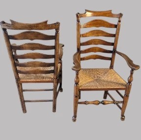A set of eight dark wood ladderback dining chairs with hand-woven rush seats, including two armchairs and six side chairs. View VII