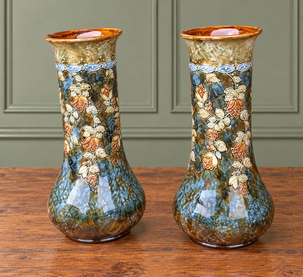 A pair of tall stoneware vases featuring mottled teal-blue glaze and raised relief trailing floral decoration with flared necks and bulbous bases. View III