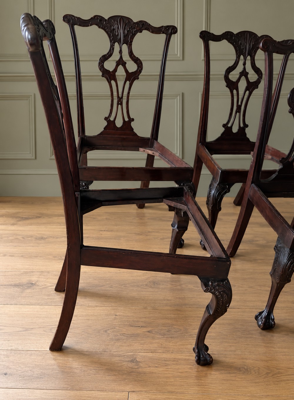A set of four mahogany Chippendale style dining chairs featuring carved pierced splats, gold-coloured velvet seats, and cabriole front legs with ball-and-claw feet. View III
