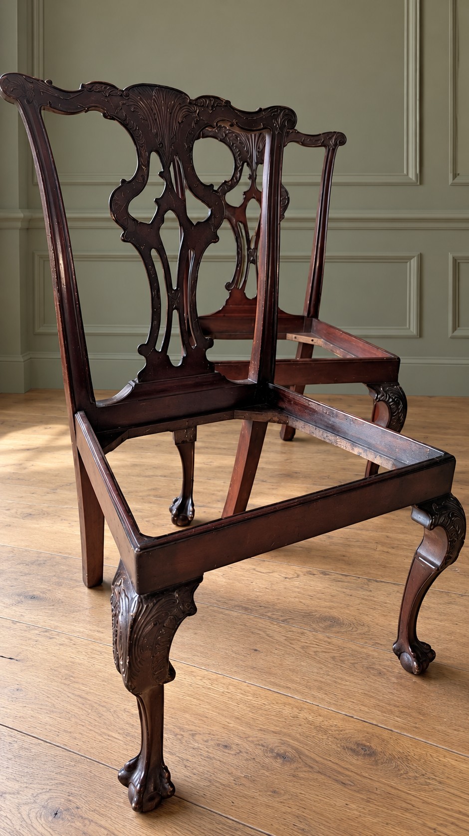 A set of four mahogany Chippendale style dining chairs featuring carved pierced splats, gold-coloured velvet seats, and cabriole front legs with ball-and-claw feet. View IV