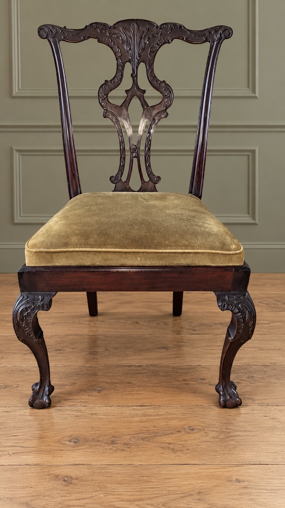 A set of four mahogany Chippendale style dining chairs featuring carved pierced splats, gold-coloured velvet seats, and cabriole front legs with ball-and-claw feet. View V